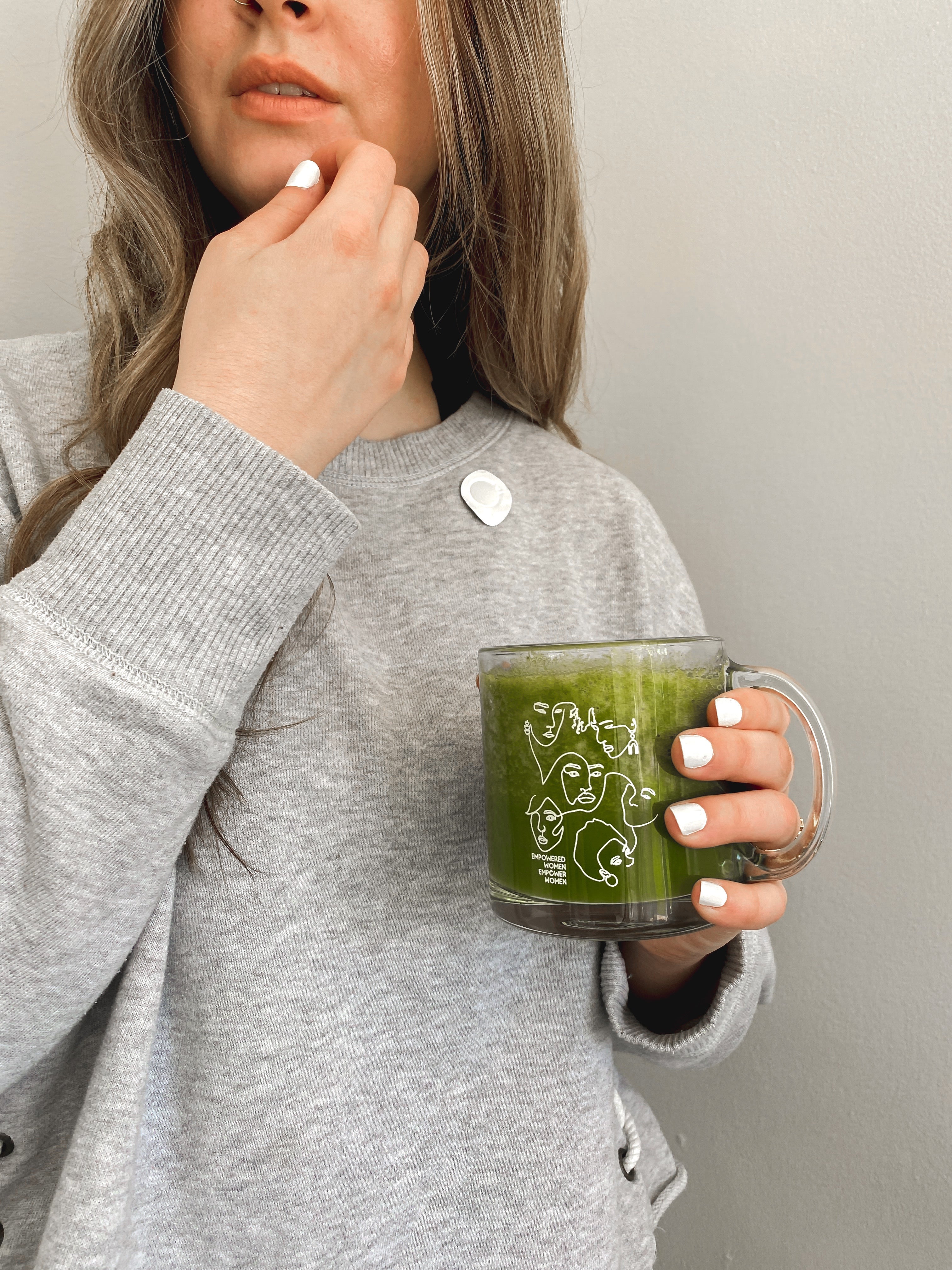 A woman drinking matcha wearing Breatherapy patch